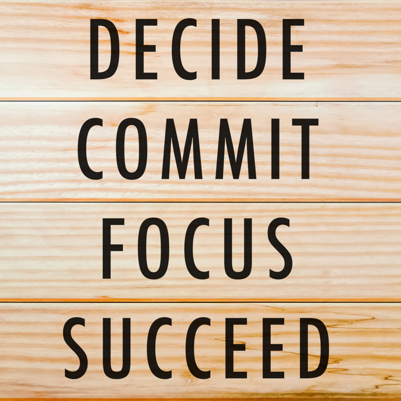 Motivational and inspirational quotes - Decide, commit, focus, succeed with wooden background.